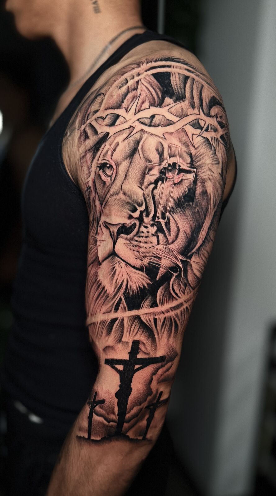 Black and grey lion and crucifix half sleeve