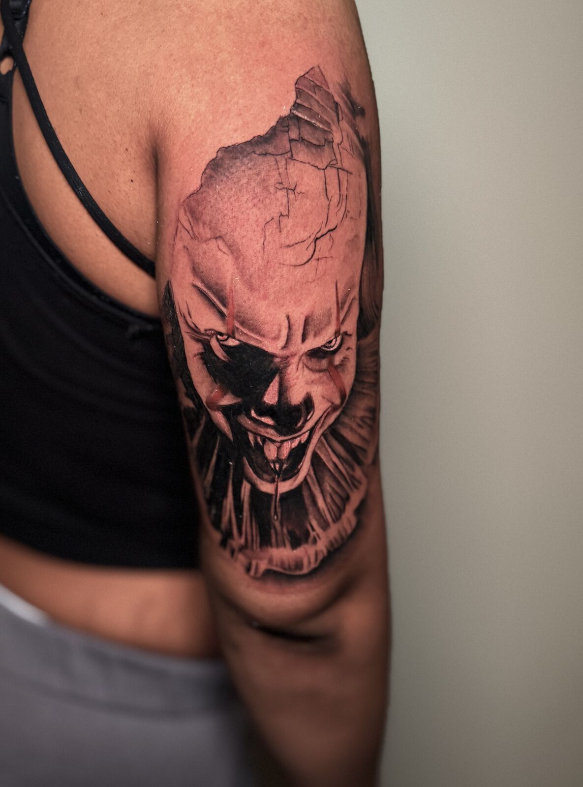 Horror clown realism piece on an upper arm