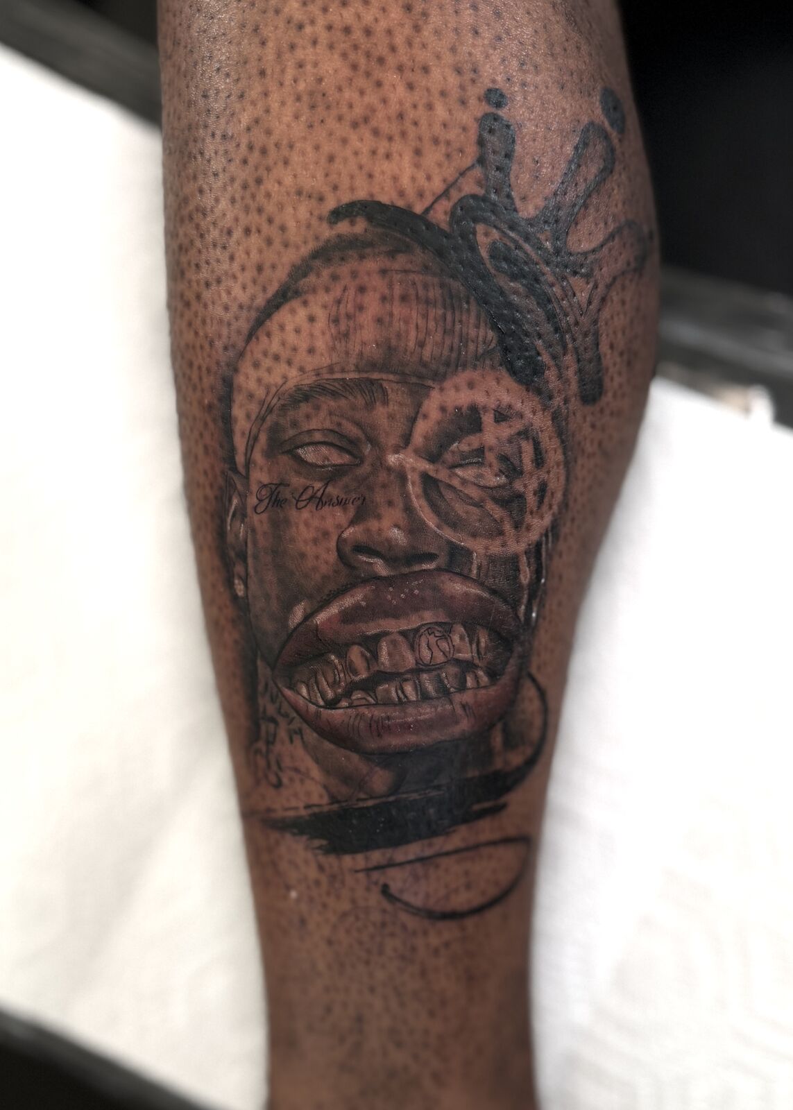 Stippled realism portrait on a forearm