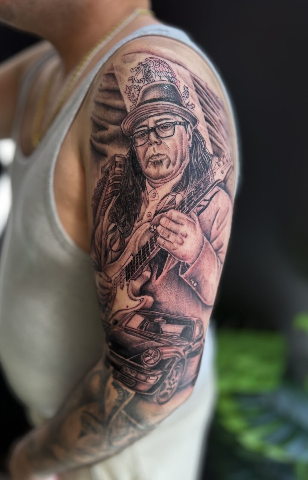 Portrait sleeve of a musician with a guitar and classic car